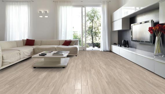 Room scene with white couch and tan laminate flooring