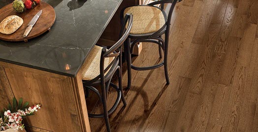 Room scene with brown wood flooring and chairs