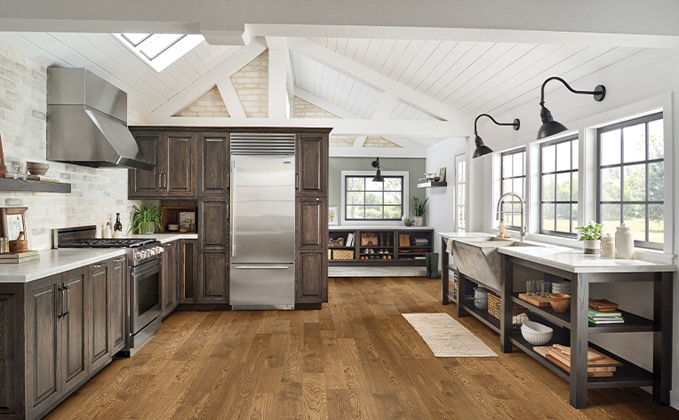 wood look engineered hardwood in kitchen with three windows and grey fridge